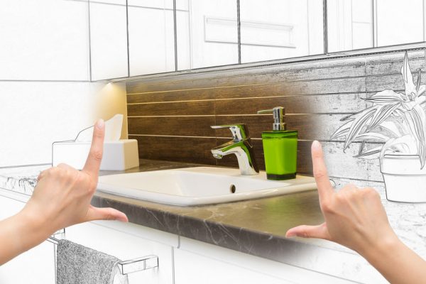 Female hands framing custom bathroom design.