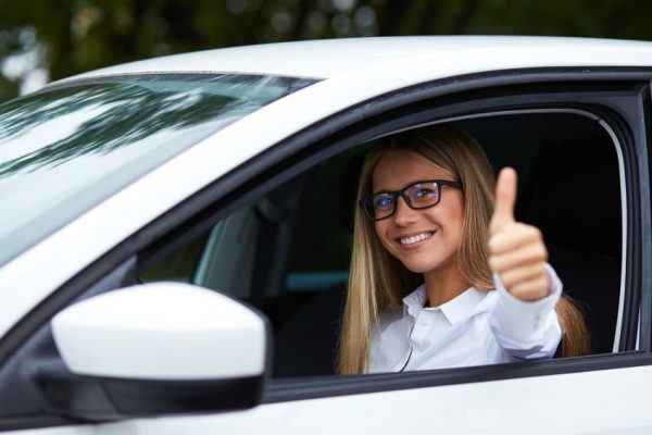 Woman makes gesture with thumb up