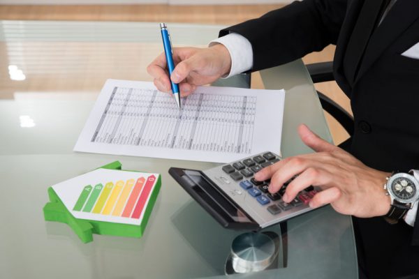 Businessman Calculating Energy Efficiency Rate