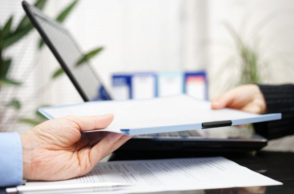 businessman and businesswoman are exchanging document or contrac