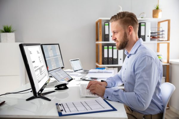 Businessperson Calculating E-Invoice