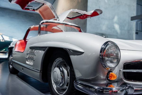 Doors wide open like a wings. Red vintage car on a auto show