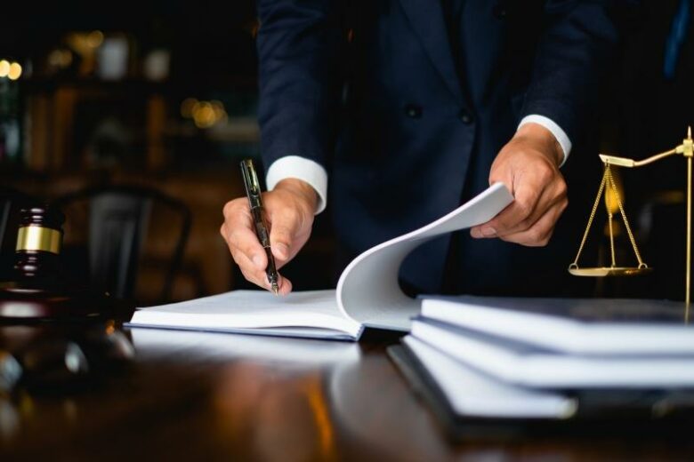 Close,Up,Lawyer,Businessman,Working,Or,Reading,Lawbook,In,Office