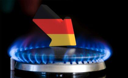 Decreased gas supplies in Germany. A gas stove with a burning flame and an arrow in the colors of the Germany flag pointing down. Concept of crisis in winter and lack of natural gas. Heating season.