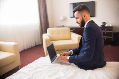 Businessman Using Laptop in Luxury Hotel