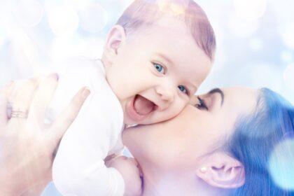 happy mother kissing baby