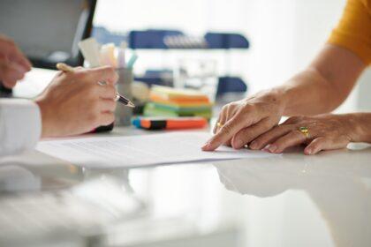 Senior Woman Signing Document