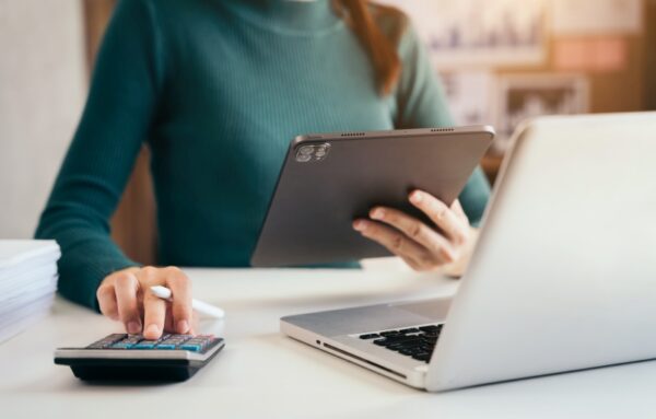 Business women or accountant working on laptop computer with bus