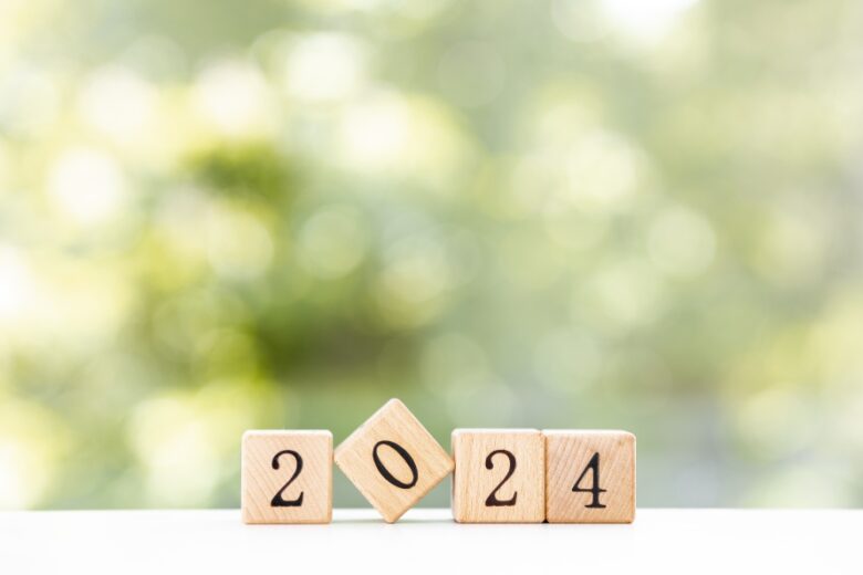 Wooden cubes with 2024 and happy new year over wooden background, banner with copy space for text, new year greeting card template