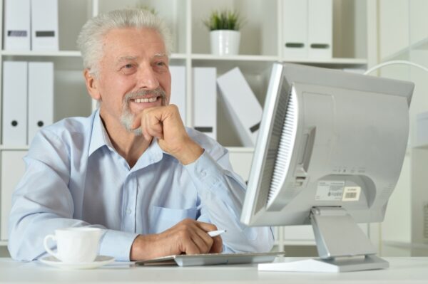 Portrait of a old business woman using laptop